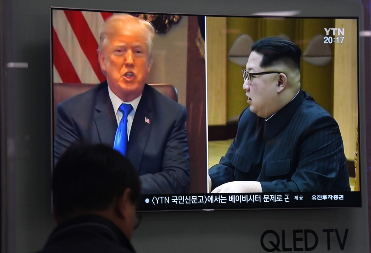 A man watches a television screen at a railway station in Seoul, South Korea, showing North Korean leader Kim Jong Un and Donald Trump, on May 24, 2018.