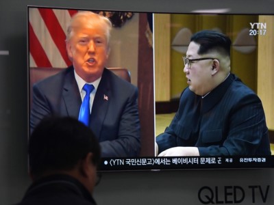 A man watches a television screen at a railway station in Seoul, South Korea, showing North Korean leader Kim Jong Un and Donald Trump, on May 24, 2018.