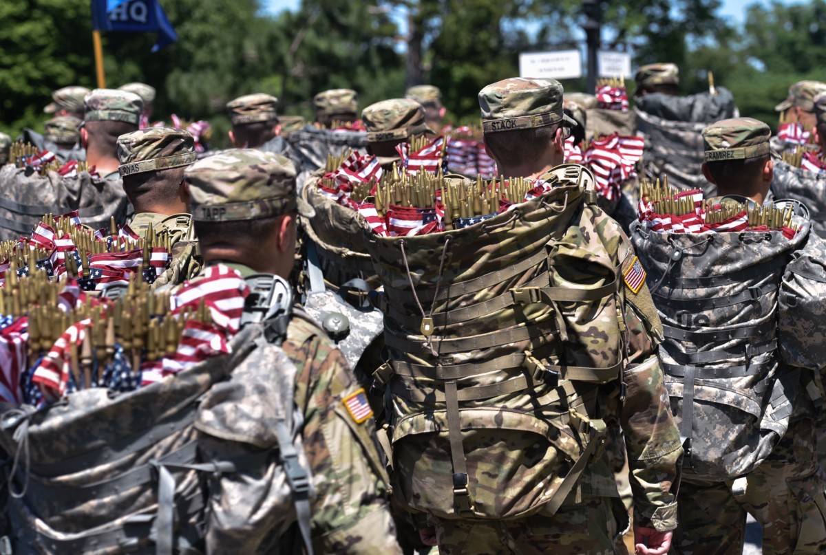 Members of the Old Guard arrive with packs full of US flags to place on graves at Arlington National Cemetery on May 24, 2018, ahead of Memorial Day in Arlington, Virginia.