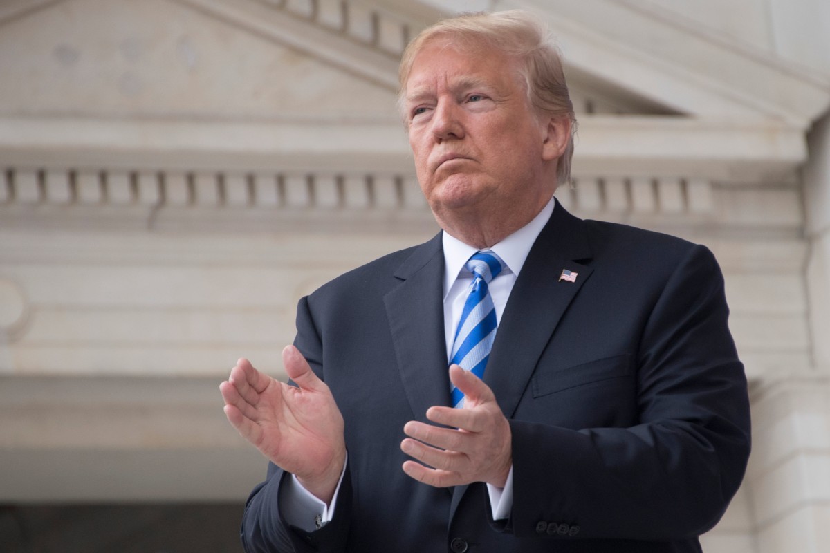 Donald Trump applauds while speaking at a Memorial Day ceremony at Arlington National Cemetery in Arlington, Virginia, on May 28, 2018.