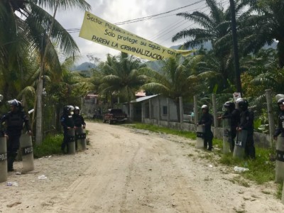 Police from various units are present May 3 in Pajuiles, in northern Honduras, to escort dam construction machinery past a community resistance camp.