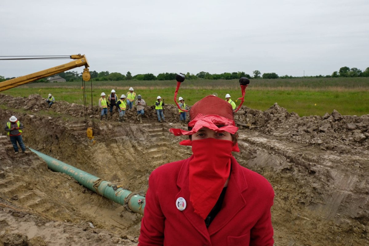 A protester in a crawfish costume pauses for a picture after stopping work at a Bayou Bridge Pipeline construction site with a musical performance. Activists opposed to the pipeline are finding increasingly creative ways to disrupt constructions. 
