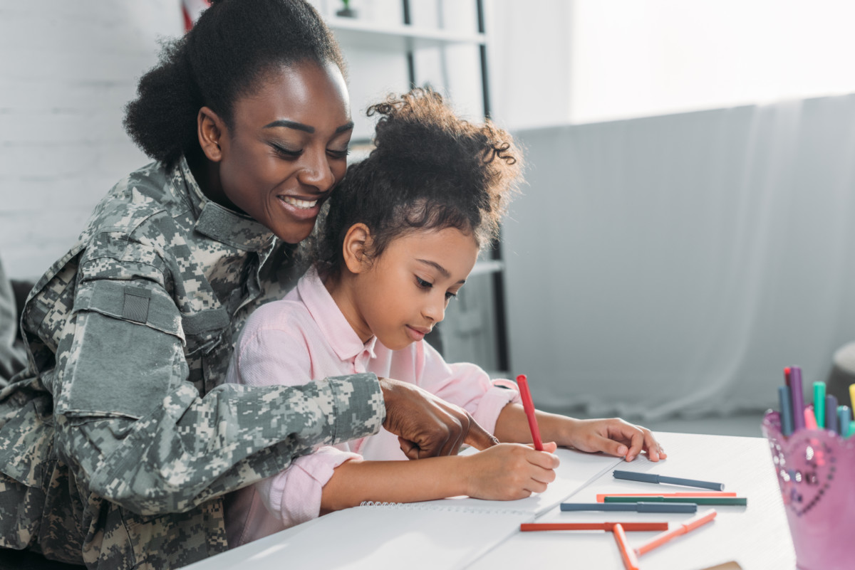 A vet does homework with her child.