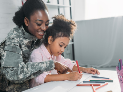 A vet does homework with her child.