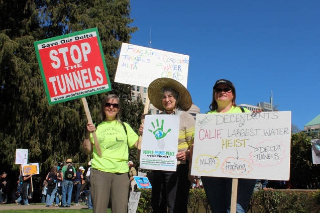 Barbara Daly, Nancy Price and a member of North Delta Cares point out the ties between fracking, the BDCP and the MLPA Initiative. (Photo by Dan Bacher)