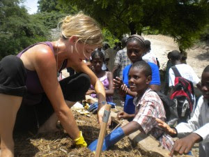 Sasha Kramer tests SOIL compost with the help of some eager volunteers.