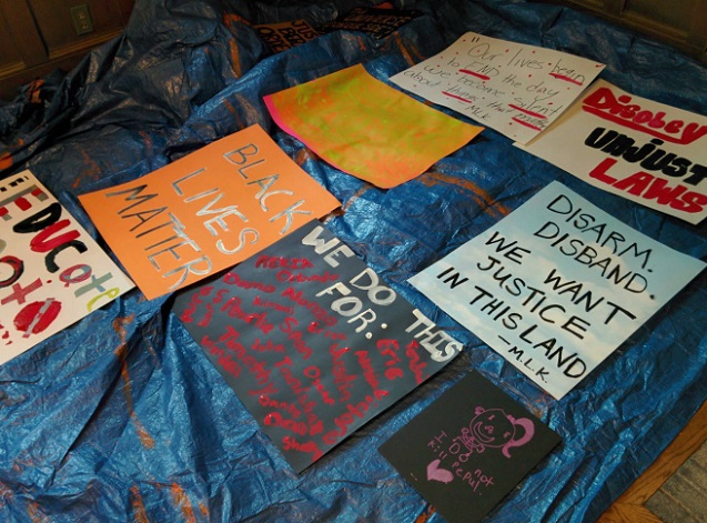 A batch of painted signs, included one inspired by the BYP 100 chant, “We do this for Marissa! We do this for Tanesha! We do this for Mike Brown! We do this for Rekia! We do this for Damo! We do this till we free us!” (Photo: Kelly Hayes)