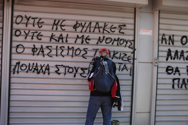 Activists writing political graffiti on walls, neighborhood of Petralona. (Photo: Joshua Tartakovsky)