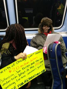 Chicago Light Brigade member Cairá Lee Conner discusses the reparations ordinance with commuters on the Red Line. (Photo: Kelly Hayes)