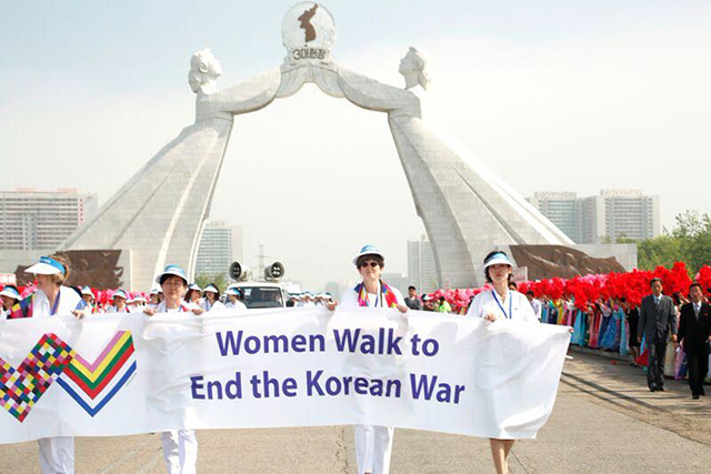 Ann Wright, Hye-Jung Park, and Brinton Lykes walk with North Korean women in Pyongyang from Reunification Monument. (Photo: Niana Liu)