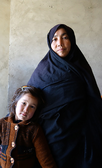 Safeh Zakira stands with her youngest daughter, age 5. (Photo: Courtesy of Carolyn Coe)