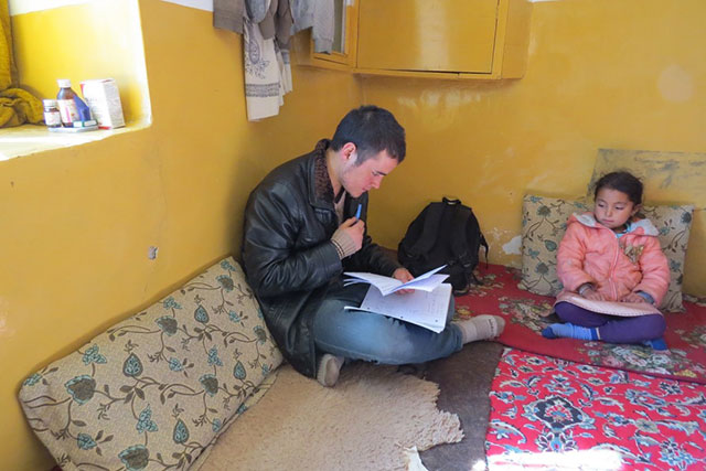 Zek conducting the survey in Zuhair's home. Zuhair's sister is looking on. (Photo: Dr. Hakim)