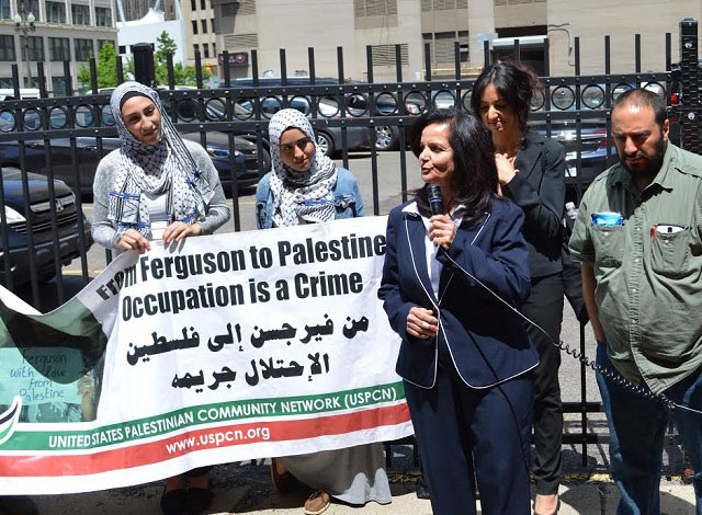 Rasmea Odeh address her supporters, flanked by legal team member Huwaida Arraf, members of Students for Justice in Palestine-Wayne State and colleague Hatem Abudayyeh. (Photo: Jimmy Johnson)