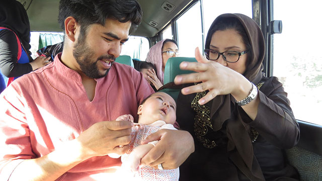 Basir with his wife and newborn baby.