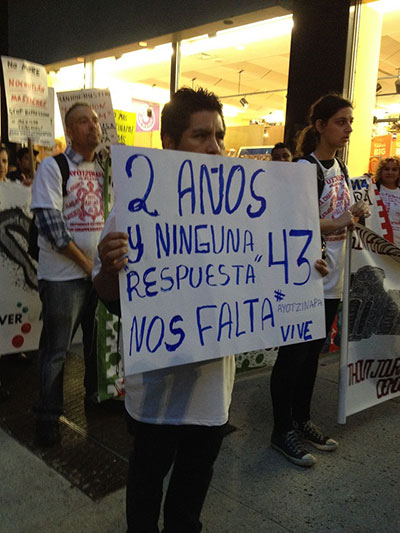 A participant in the march holds a sign that reads, 