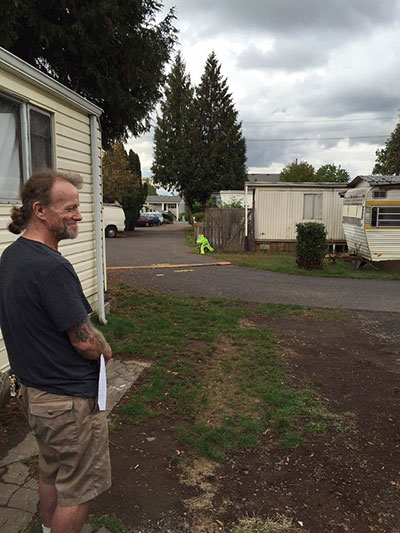 Hugh Elliott, co-op member, outside his Oak Leaf mobile home. (Photo: Thacher Schmid)