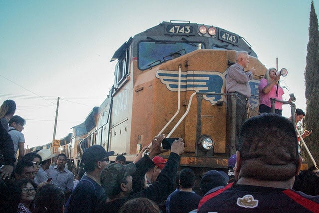 Protesters climb onto a stopped train. 