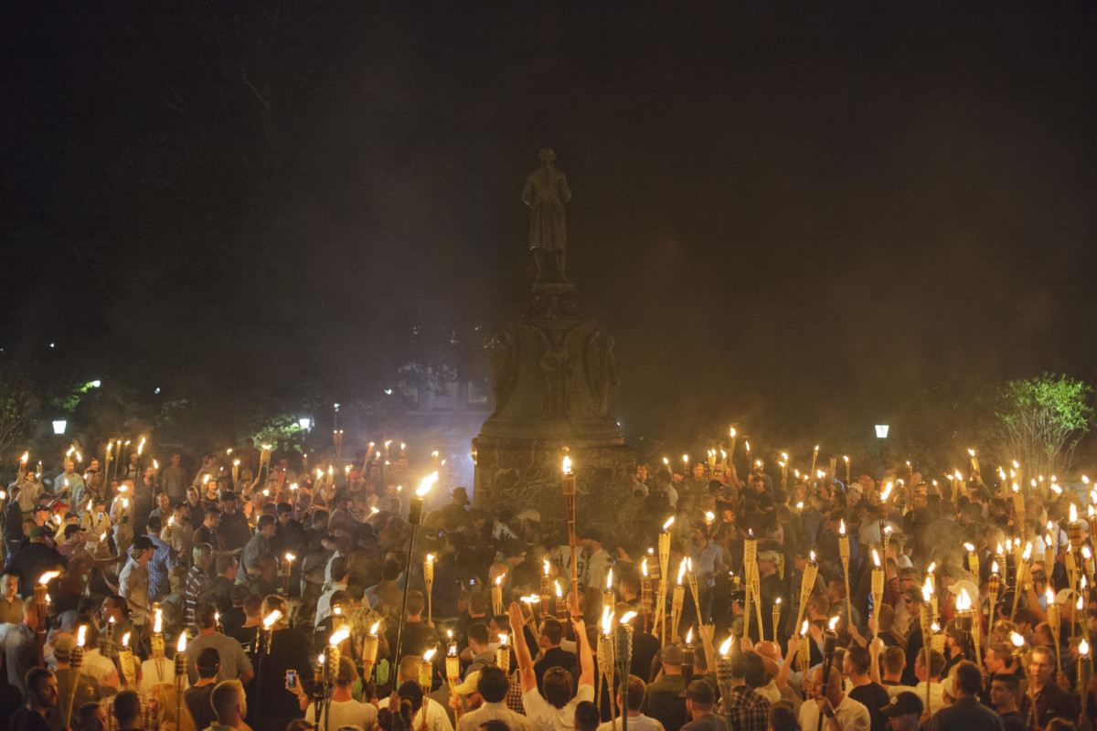 Neo Nazis, Alt-Right, and white supremacists encircle counter protestors at the base of a statue of Thomas Jefferson after marching through the University of Virginia campus with torches in Charlottesville, Virginia, on August 11, 2017.