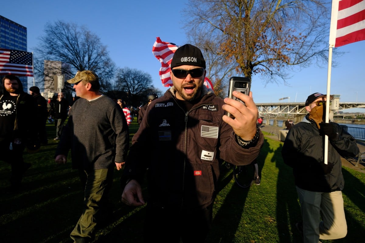 Joey Gibson, leader of the Patriot Prayer group, leads his supporters along the waterfront in Portland, Oregon, on December 9, 2017.