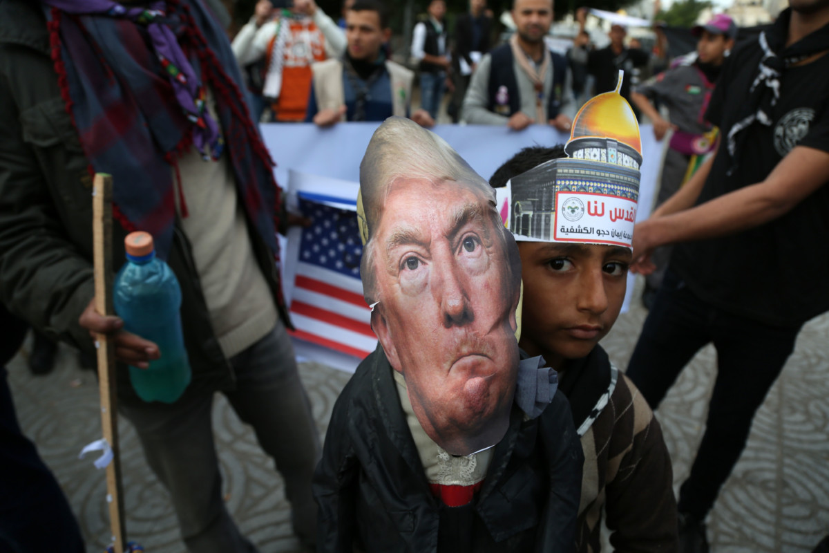 Palestinians carry an effigy bearing a poster of President Donald Trump during a protest against Trump's decision to recognize Jerusalem as Israel's capital, in Gaza City, December 13, 2017.