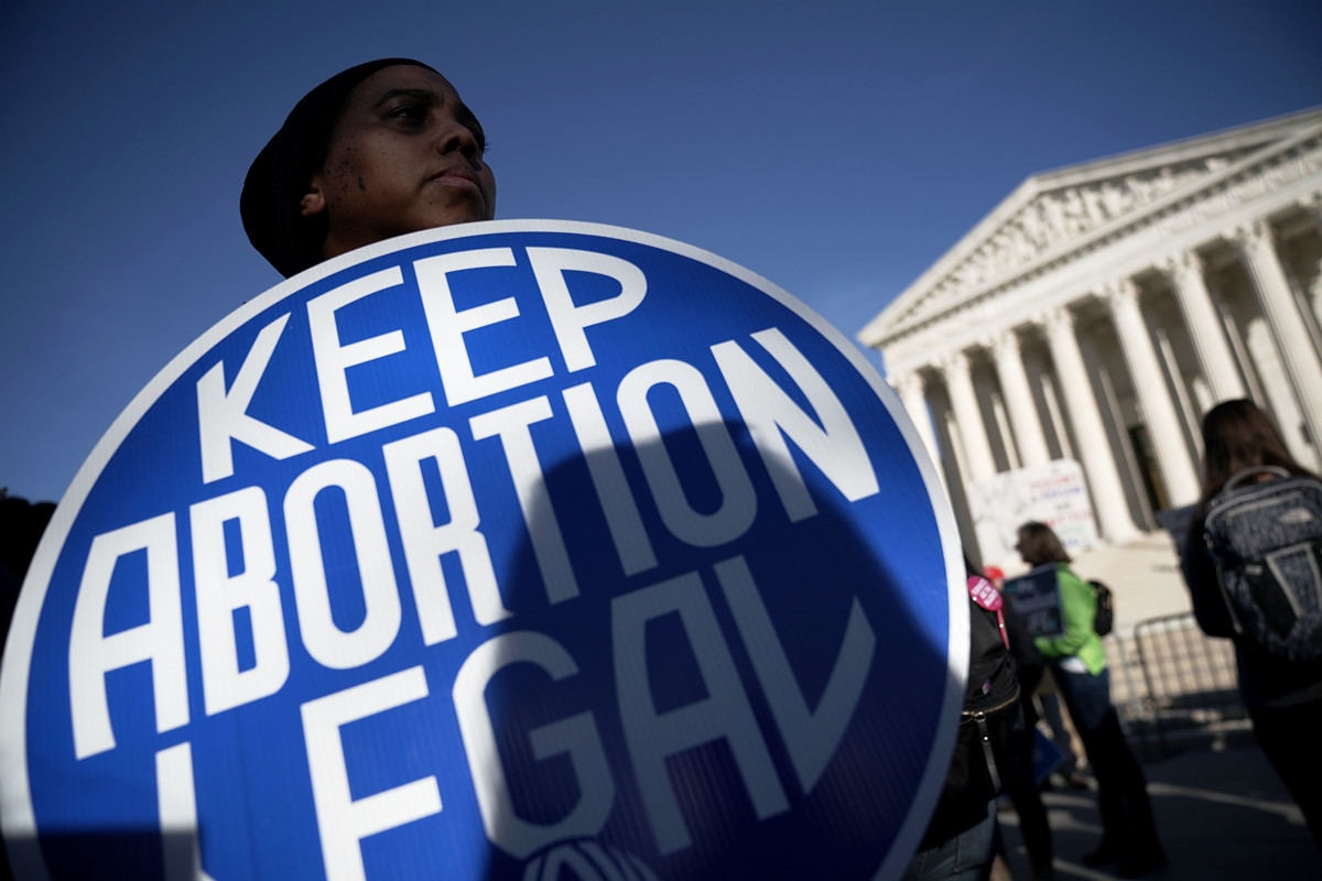 A pro-choice activist holds a sign as she counter-protests in front of the the US Supreme Court during the 2018 March for Life January 19, 2018, in Washington, DC.