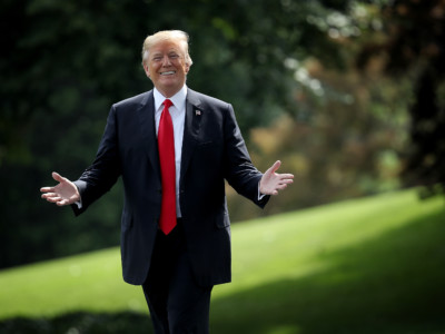 US President Donald Trump gestures toward journalists shouting questions as he departs the White House May 29, 2018 in Washington, DC.