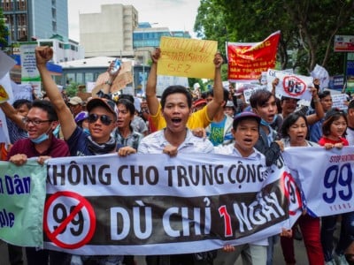 Vietnamese protesters shout slogans against a proposal to grant companies lengthy land leases during a demonstration in Ho Chi Minh City on June 10, 2018.
