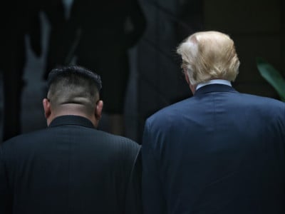 North Korean leader Kim Jong-un and President Donald Trump walk during their summit at the Capella Hotel on Sentosa island on June 12, 2018, in Singapore.