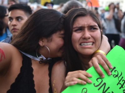Protestors comfort each other during a "Families Belong Together March" against the separation of children of immigrants from their parents, in Los Angeles, California, on June 14, 2018.