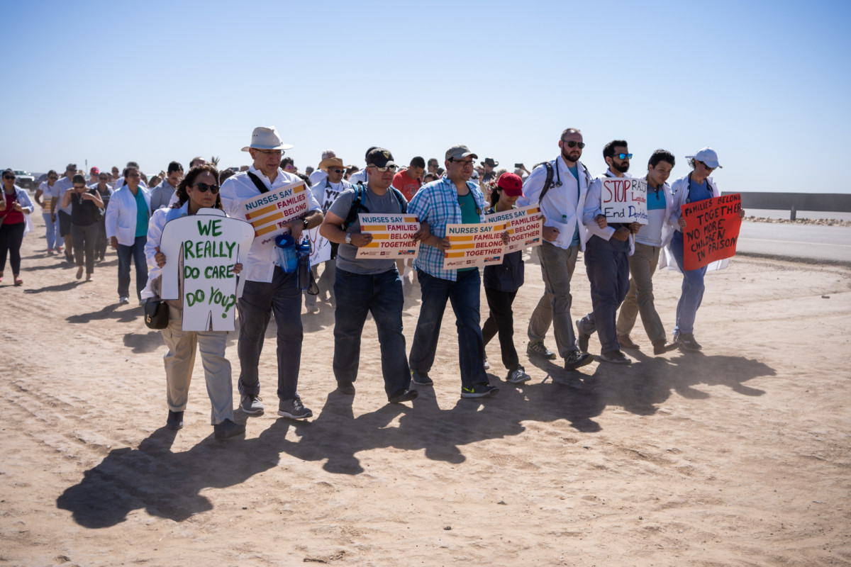 Doctors, nurses and medical students march to the entrance of the Tornillo Port of Entry in Tornillo, Texas, to demand an end to separation of immigrant children from their parents, June 23, 2018.