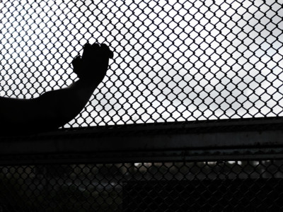 A Cuban man seeking asylum waits along the border bridge after being denied into the Texas city of Brownsville which has become dependent on the daily crossing into and out of Mexico on June 22, 2018, in Brownsville, Texas.