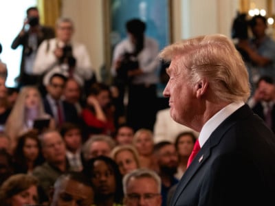 President Donald Trump welcomes guests at an event where he signed an executive order establishing a National Council for the American Worker.