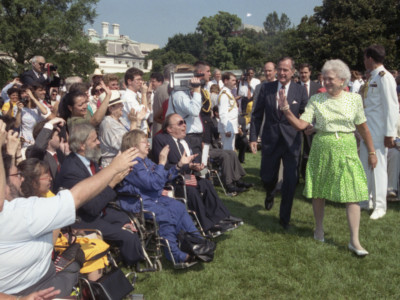 President George Bush and Barbara Bush receive applause by some of the 2,000 people from major disability groups that gathered to witness the signing of the Americans with Disabilities Act (ADA), July 26, 1990.
