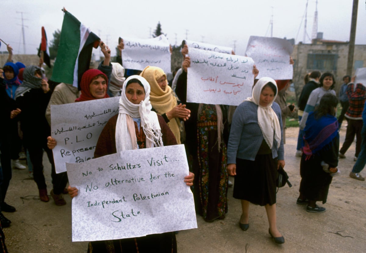 Palestinian women demonstrators carry signs during a protest in Ramallah during the First Intifada.