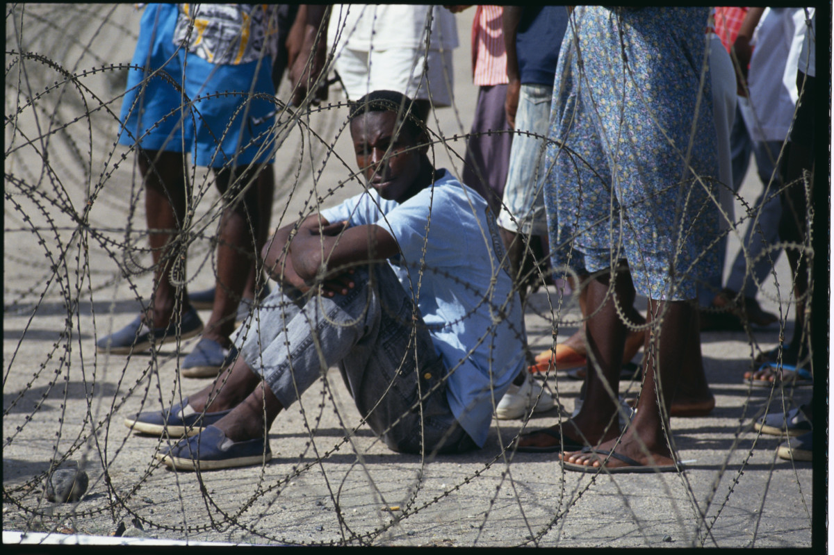 Haitian refugees are detained at the United States Naval Base in Guantanamo Bay after the deposing of Haitian President Aristide.