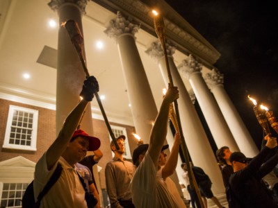 Young men hold up torches on the steps of the rotunda as other Neo Nazis, Alt-Right, and White Supremacists march through the University of Virginia Campus with torches in Charlottesville, Virginia, on August 11, 2017.