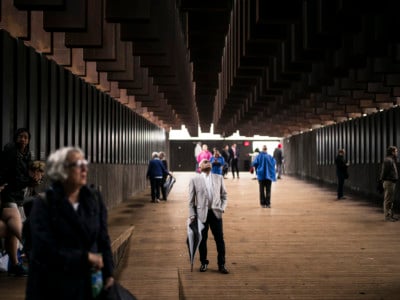 Ed Sykes (center), 77, visits the National Memorial For Peace And Justice on April 26, 2018 in Montgomery, Alabama. Sykes was distraught when he discovered his last name in the memorial. The memorial is dedicated to the legacy of enslaved black people and those terrorized by lynching and Jim Crow segregation in America.