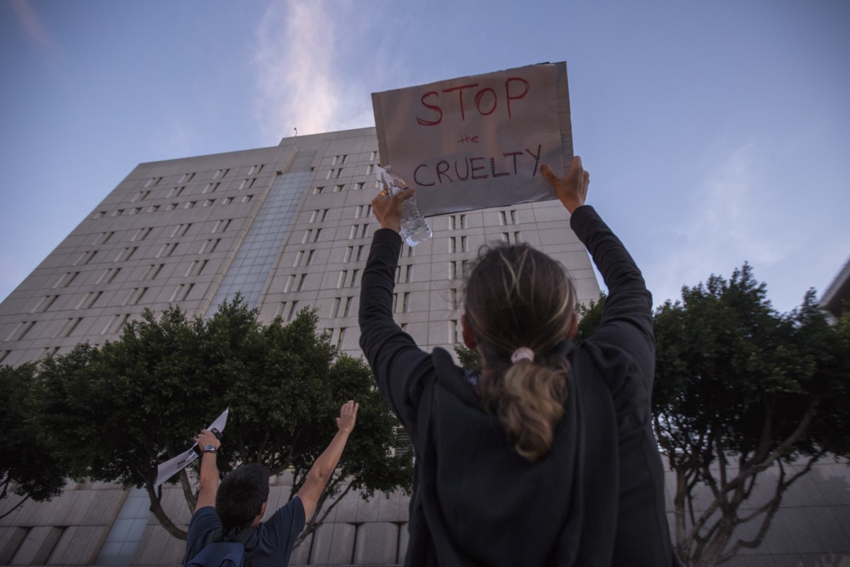 People call 'you are not alone' to immigrant detainees inside the Metropolitan Detention Center during a protest of the Trump administration policy of removing children from parents arrested for illegally crossing the US-Mexico border on June 14, 2018, in Los Angeles, California.