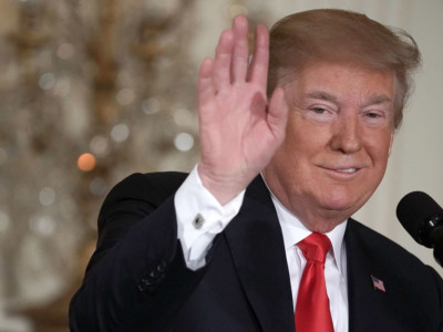 President Donald Trump waves during a meeting of the National Space Council at the East Room of the White House June 18, 2018, in Washington, DC.
