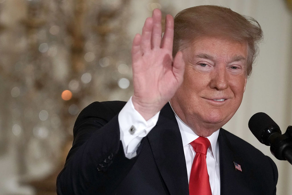 President Donald Trump waves during a meeting of the National Space Council at the East Room of the White House June 18, 2018, in Washington, DC.