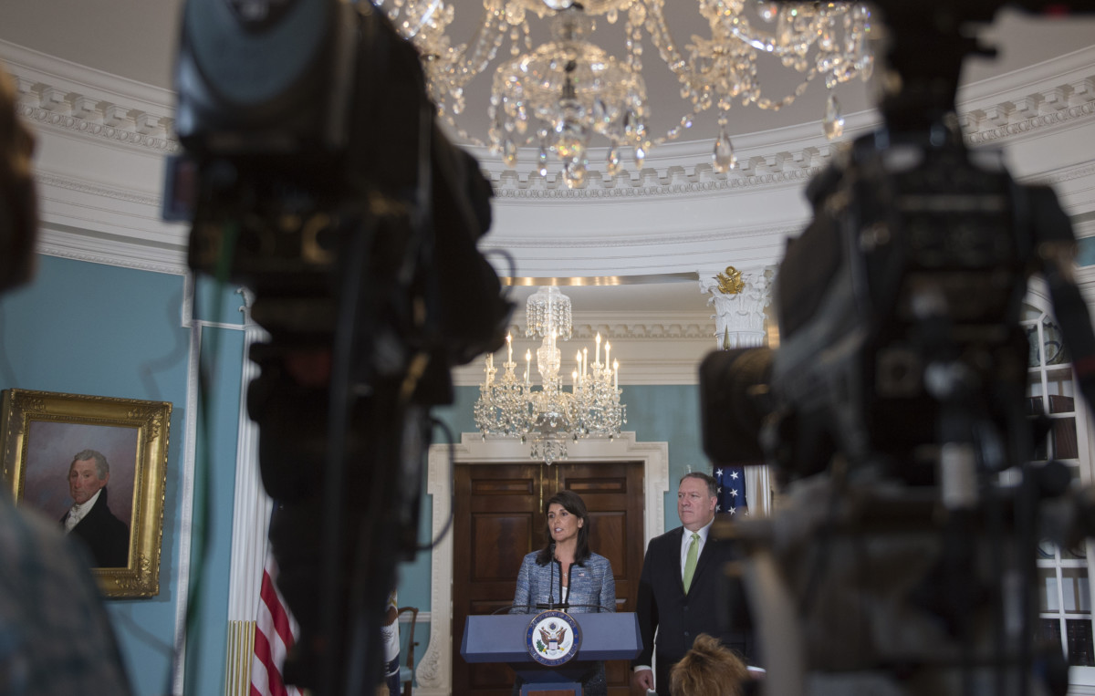 Secretary of State Mike Pompeo looks on as Ambassador to the United Nations Nikki Haley speaks at the US Department of State in Washington, DC, on June 19, 2018.