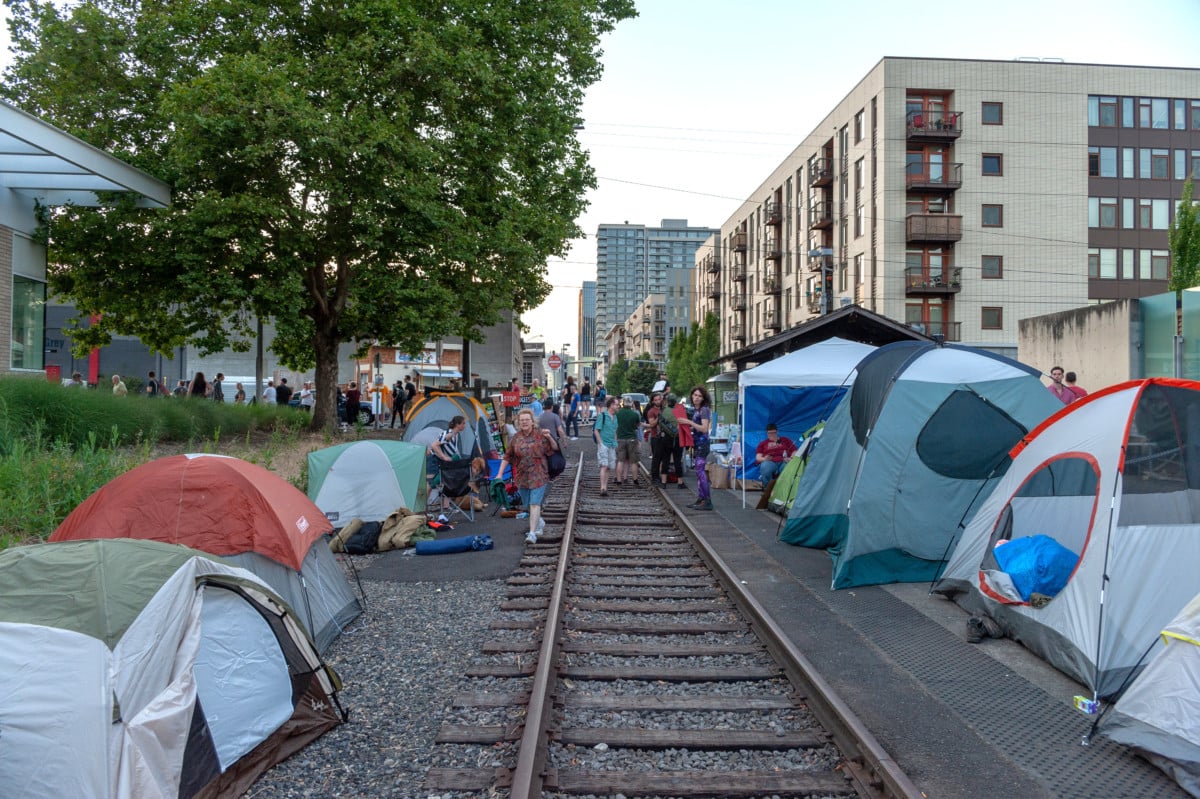 Tents are planted on either side of the old trolley rail at OccupyICEPDX, just in front of the ICE Portland headquarters in southwest Macadam on June 19, 2018, in Portland, Oregon.