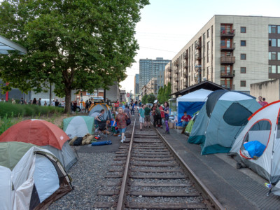 Tents are planted on either side of the old trolley rail at OccupyICEPDX, just in front of the ICE Portland headquarters in southwest Macadam on June 19, 2018, in Portland, Oregon.