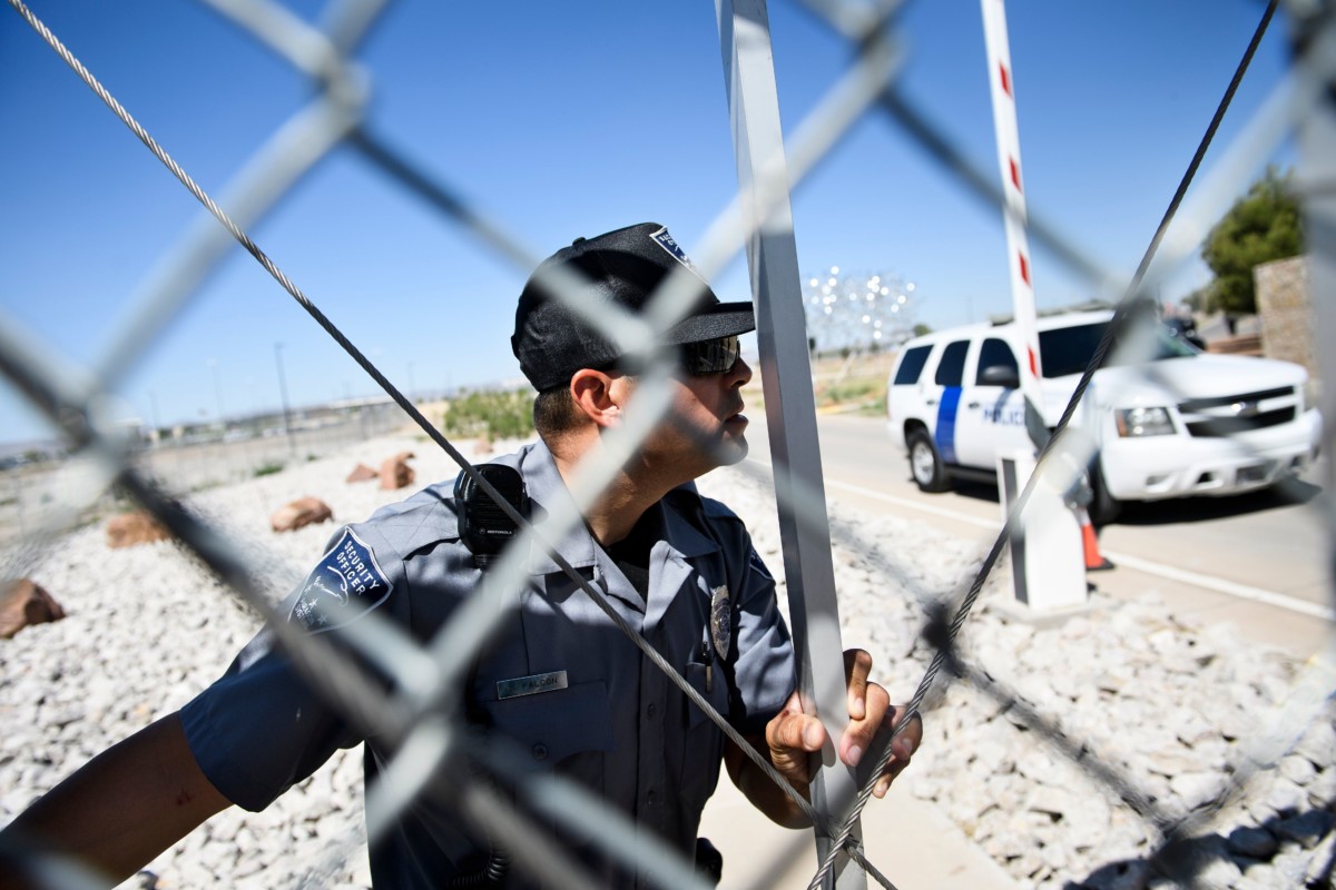 A security officer closes a gate to the Tornillo Port of Entry as mayors and others try and enter to visit with immigrant minors who are housed there June 21, 2018, in Tornillo, Texas.