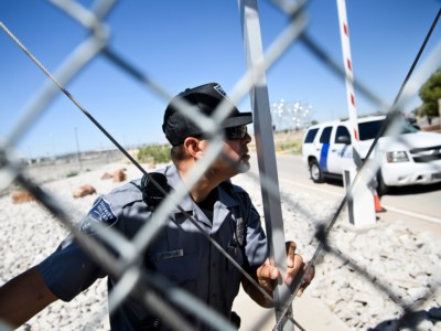 A security officer closes a gate to the Tornillo Port of Entry as mayors and others try and enter to visit with immigrant minors who are housed there June 21, 2018, in Tornillo, Texas.