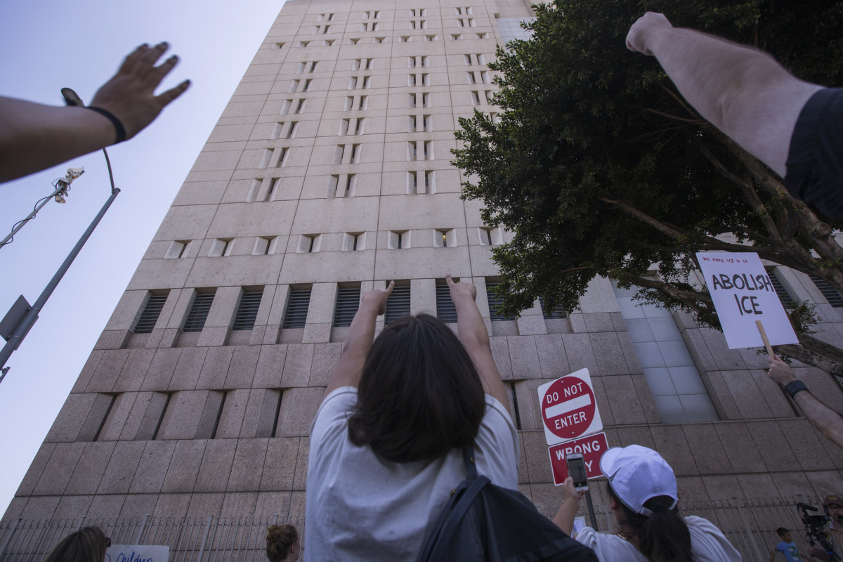 People call out words of encouragement to detainees held inside the Metropolitan Detention Center after marching to decry Trump administration immigration and refugee policies on June 30, 2018, in Los Angeles, California.