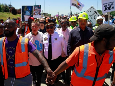 Father Michael Pfleger (2nd left) and Reverend Jesse Jackson (2nd right) walk with Chicago Police Superintendent Eddie Johnson during an anti-violence protest, which shut down the Dan Ryan Expressway in Chicago, July 7, 2018.