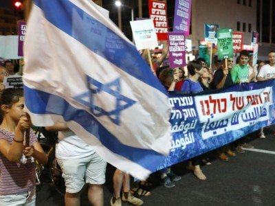 Demonstrators attend a rally to protest against the 'Jewish Nation-State Bill' in the Israeli coastal city of Tel Aviv on July 14, 2018.