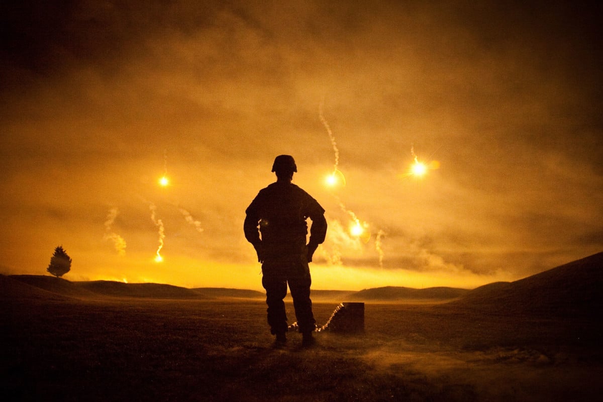 A soldier observes the pyrotechnics finale for an Army competition conducted at Fort Lee, Virginia, October 5, 2011.