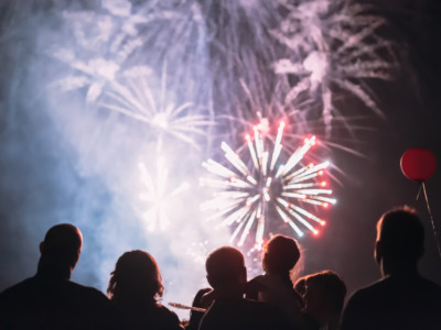 A crowd watches fireworks together